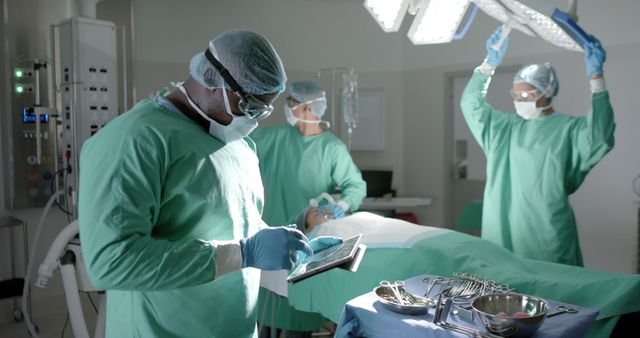 Surgeons Performing Surgery Under Bright Operating Room Lights - Download Free Stock Images Pikwizard.com