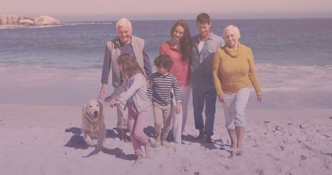 Multigenerational Family Enjoying Beach Walk with Dog