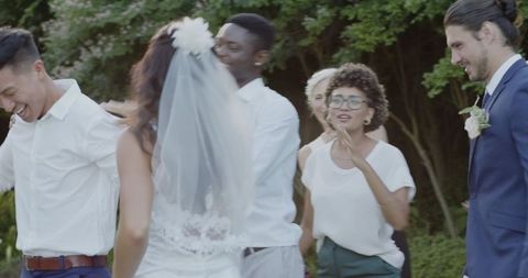 Joyful Wedding Celebration with Guests Smiling Outdoors