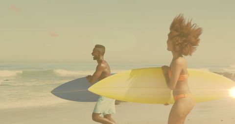 Excited Couple Walking with Surfboards on Sunny Beach