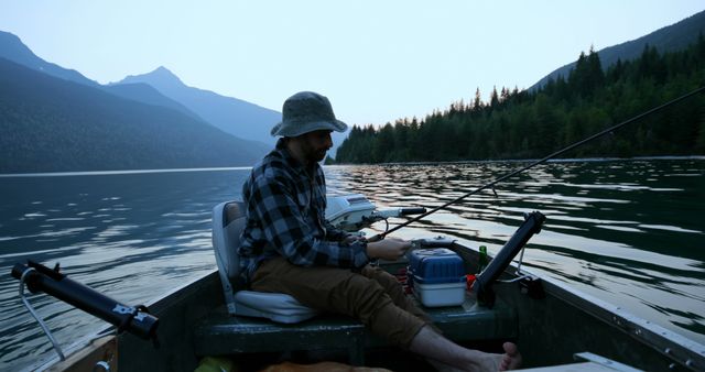 Man Fishing on Lake in Mountainous Wilderness at Sunrise - Download Free Stock Images Pikwizard.com