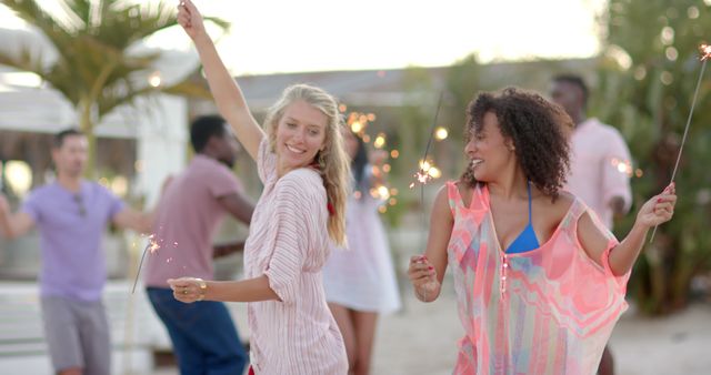 Friends Celebrating with Sparklers at Beach Party - Download Free Stock Images Pikwizard.com