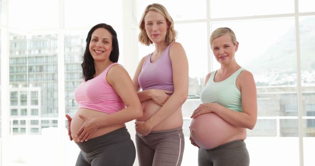 Happy Pregnant Women Smiling and Posing Together Indoors - Download Free Stock Images Pikwizard.com