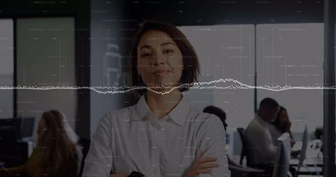 Confident Businesswoman Crosses Arms in Tech-Infused Office Setting