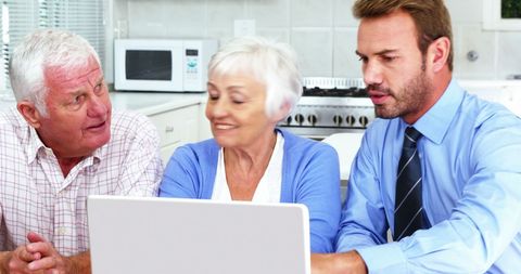 Mature Businessman Assisting Senior Couple with Technology - Download Free Stock Images Pikwizard.com