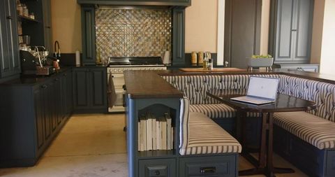 Modern Kitchen With Laptop and Cozy Seating Area