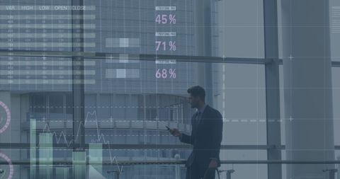 Businessman Analyzing Data Displays in Modern Office