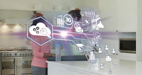 Two women collaborating in modern kitchen with holographic interface and planning overlay