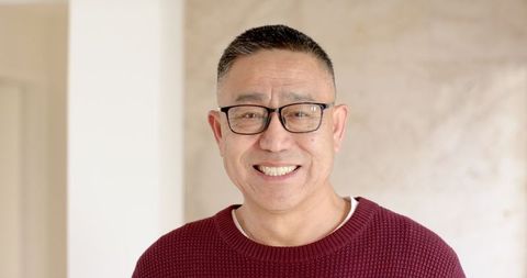 Smiling Senior Man in Cozy Knit Sweater at Home
