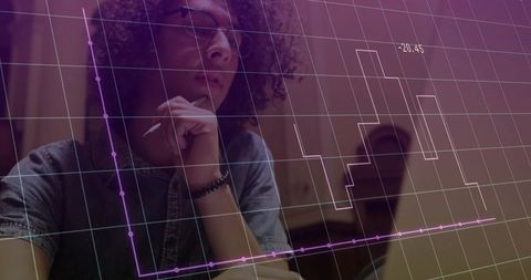 Curly-haired analyst studying data on laptop screen