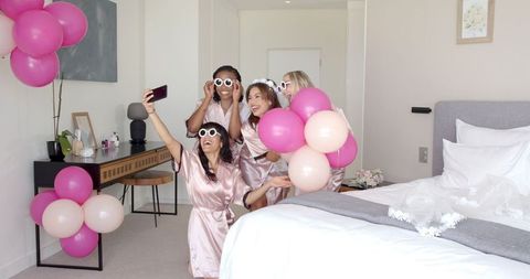 Bridal party enjoying hen celebration with selfies and balloons