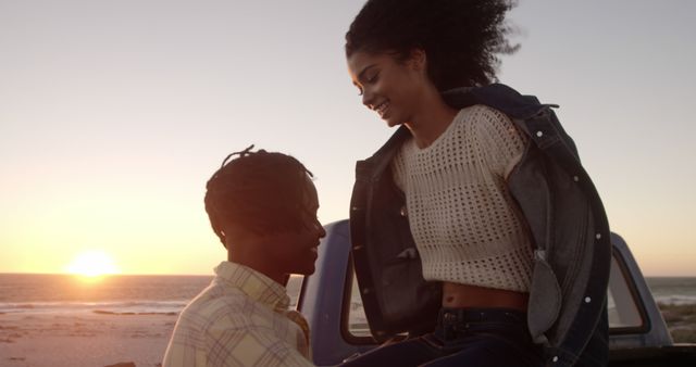 A young couple is enjoying a romantic moment at the beach during sunset. This image is perfect for themes related to romance, travel, lifestyle, and leisure. The warm colors and natural setting emphasize the joy and connection between the individuals. Ideal for blog posts, social media, advertisements, and magazines focusing on couples, relationships, and coastal getaways.