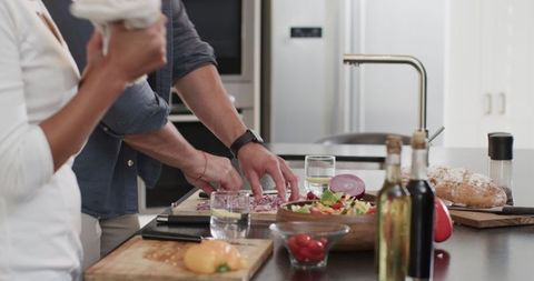 Couple Enjoying Quality Time While Cooking Together in Modern Kitchen