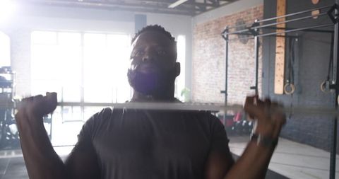 Determined Athlete Lifting Barbell in Industrial Gym Setting