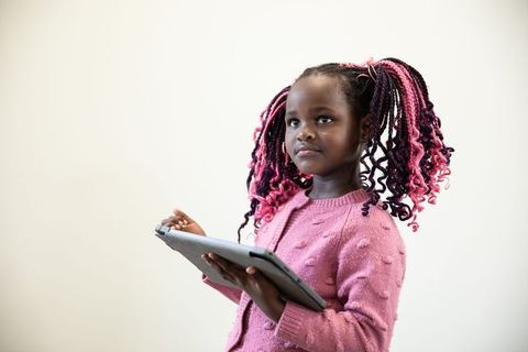 Young girl engaging with tablet and modern technology