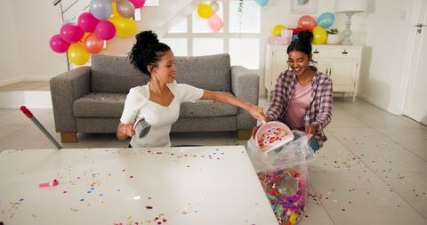 Women Enjoying Afterparty Cleanup With Confetti and Balloons