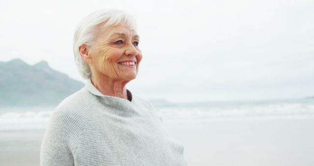 Happy Elderly Woman Enjoying a Day at the Beach - Download Free Stock Images Pikwizard.com