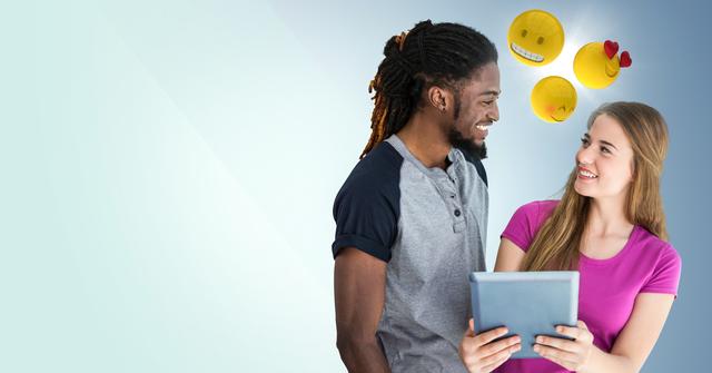Digital composite of Man and woman with tablet and emojis against blue background