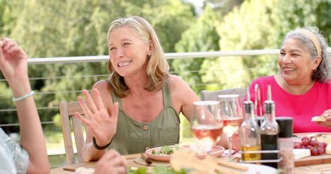 Friends Enjoying Lively Outdoor Meal Gathering Together