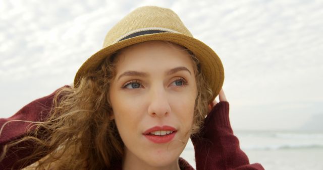 A young Caucasian woman wearing a straw hat is at the beach, with copy space - Download Free Stock Photos Pikwizard.com