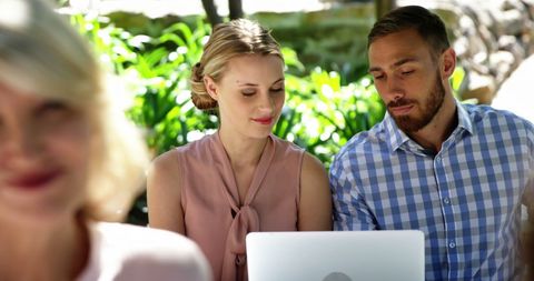 Young Couple Engaged with Laptop at Outdoor Restaurant - Download Free Stock Images Pikwizard.com