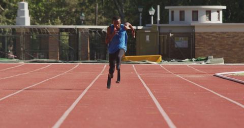 Determined Athlete with Prosthetic Legs Sprinting on Track - Download Free Stock Images Pikwizard.com