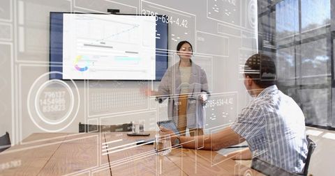 Businesswoman presenting data with augmented analytics overlay in modern conference room