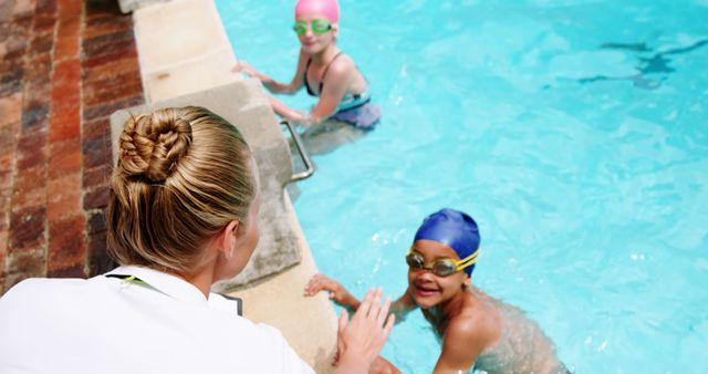 Swim Instructor Coaching Children in Pool - Download Free Stock Images Pikwizard.com