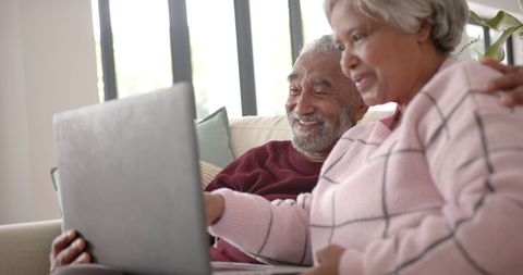 Happy Senior Couple Bonding Over Laptop in Cozy Living Room - Download Free Stock Images Pikwizard.com
