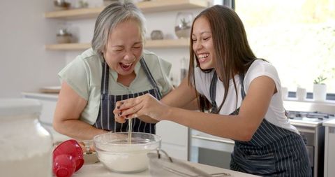 Grandmother and Granddaughter Joifully Baking Together