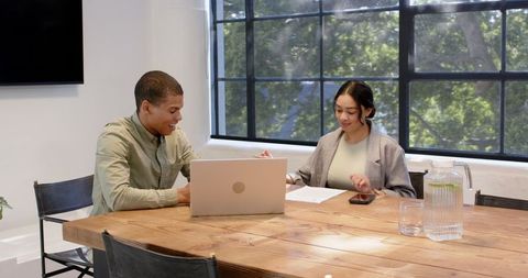 Diverse Colleagues Collaborating in Bright Office Meeting Room
