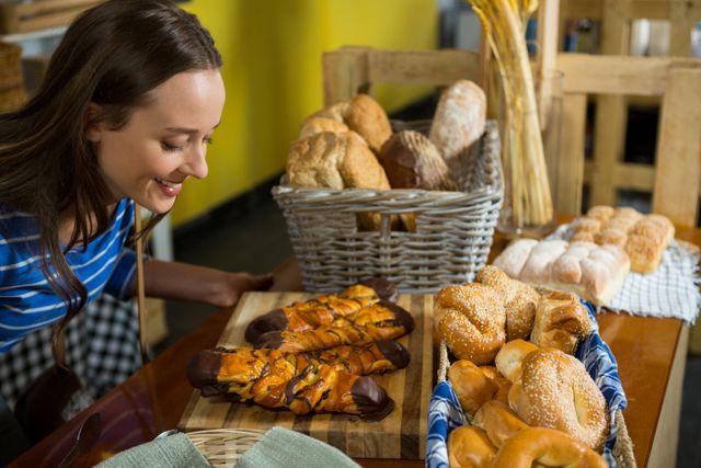 Smiling Woman Enjoying Freshly Baked Pastries in Bakery - Download Free Stock Photos Pikwizard.com