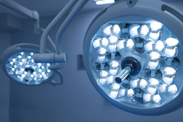 This image shows modern surgical lights in an operation theater, highlighting advanced medical equipment used in surgeries. Ideal for use in healthcare industry publications, medical equipment advertisements, hospital brochures, and educational materials about surgical procedures.