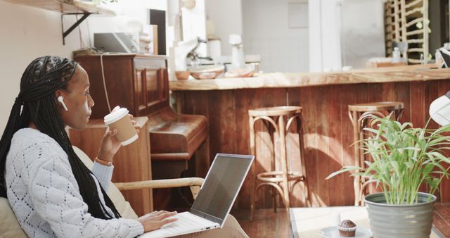 Young Woman Relaxing in Cozy Coffee Shop with Laptop and Coffee - Download Free Stock Images Pikwizard.com