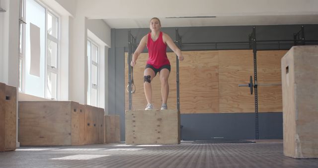 Woman jumping on plyo box in gym performing exercise - Download Free Stock Images Pikwizard.com