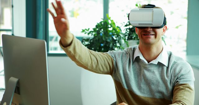 Smiling Man Using Virtual Reality Headset in Office - Download Free Stock Images Pikwizard.com