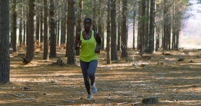 Woman Running in Forest Trail Wearing Athletic Outfit - Download Free Stock Images Pikwizard.com