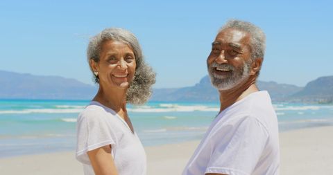 Smiling Senior Couple Enjoying Scenic Beach Day