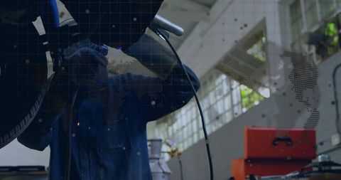 Mechanic Welding Undercarriage in Workshop with Toolkit and Spark