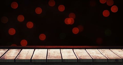 Festive Wooden Table with Blurred Red Holiday Lights Background