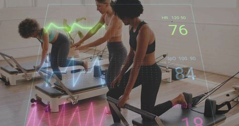Women training on pilates reformers with biometric hud overlay tracking heart rate and spo2