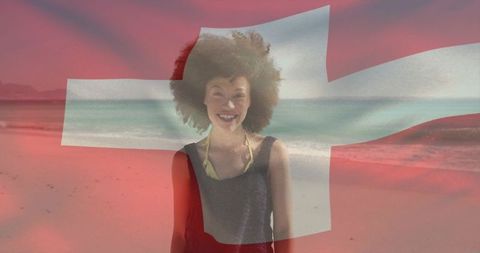 Smiling woman on beach with swiss flag overlay, coastal travel and summer tourism concept
