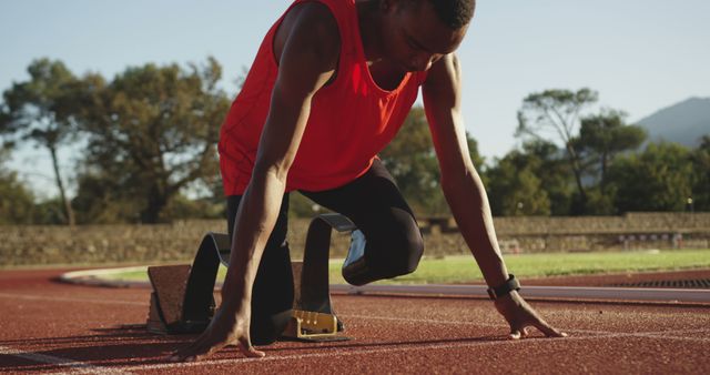 Male Athlete Preparing for Sprint on Track at Starting Blocks - Download Free Stock Images Pikwizard.com