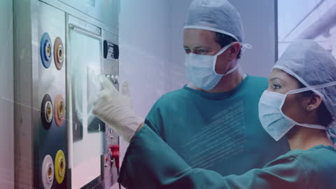 Team of Surgeons Using Digital Interface in Operating Room