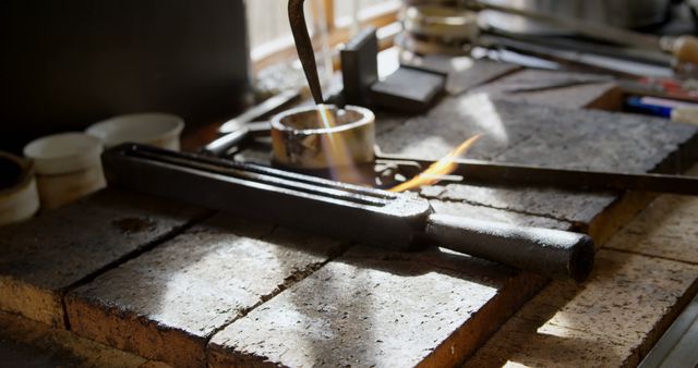 A soldering iron rests on a heat-resistant surface amidst various tools and materials in a workshop, indicating a work in progress. The scene captures the essence of craftsmanship, where precision and patience play a vital role.