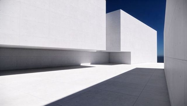 Minimalist white concrete architecture featuring monoliths casting geometric shadows