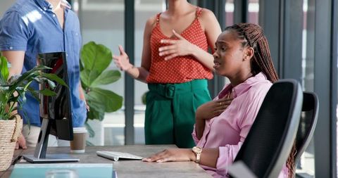Diverse Colleagues Enjoy Successful Team Meeting in Modern Office