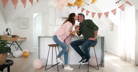 Couple Celebrating Love with Wine at Home in Bright Interior