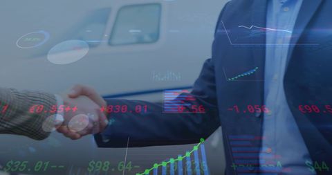 Businessmen Shaking Hands with Overlay of Financial Data Graphics
