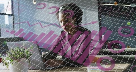 Analyst woman working on laptop reviewing digital charts